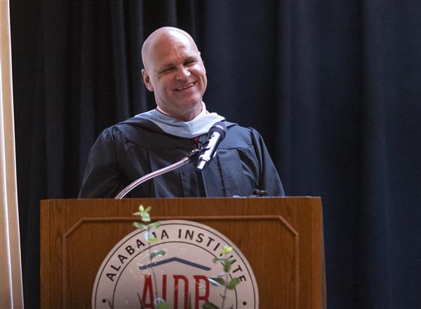 Dan Kelley speaks behind a podium to the A. S. B. class of 2024.